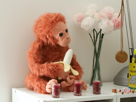 crocheted orangutan and tissue paper flowers by planetjune