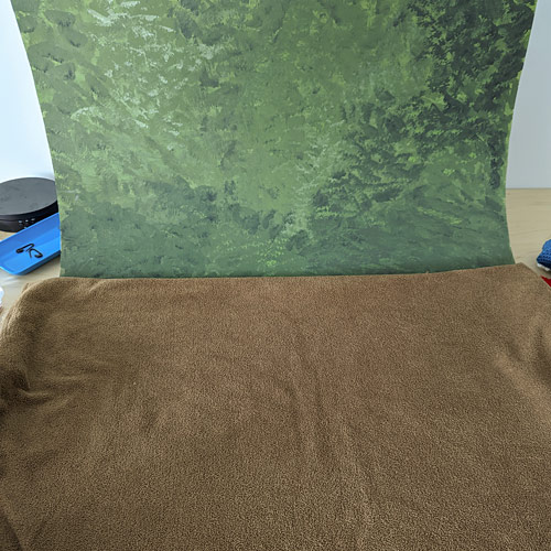 painted green backdrop and brown fabric ground for the woodland photo scene