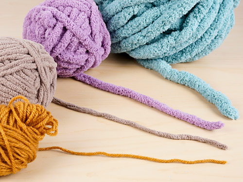 yarn for giant amigurumi (pictured: worsted weight, super bulky, and two sizes of jumbo yarns)