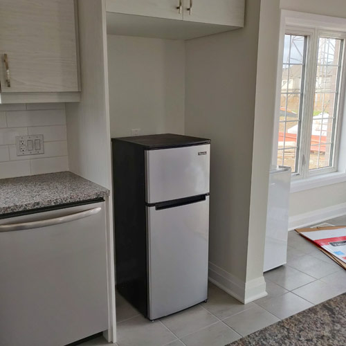 mini fridge in the space for a full-size fridge