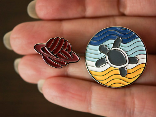 enamel pins: PlanetJune Logo and Turtle Beach designs