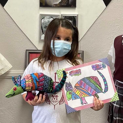 Isabella with her armadillo drawing and Maureen's crocheted armadillo